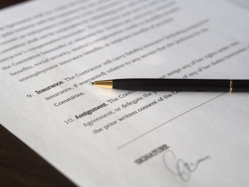 Home Close-up image of a business contract and pen, signed and ready for agreement.