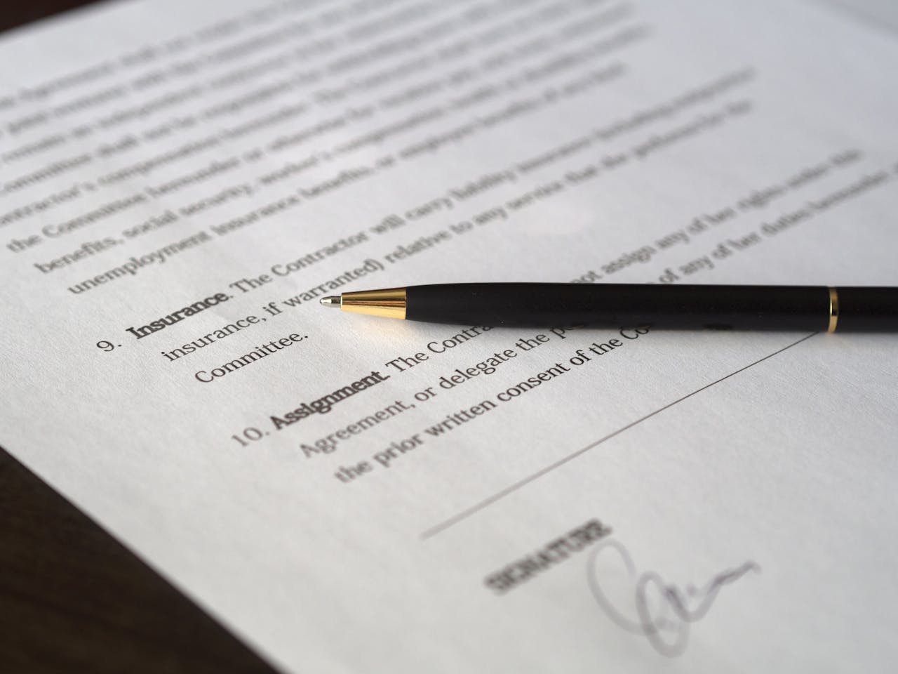 get-in-touch Close-up image of a business contract and pen, signed and ready for agreement.