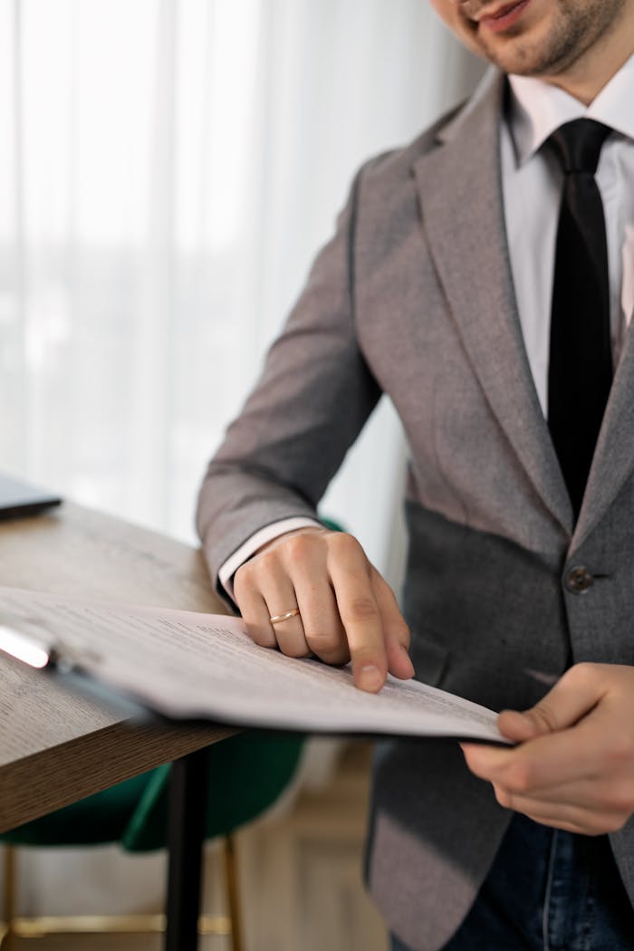 home-hero Business professional in suit reviewing important documents at the office.